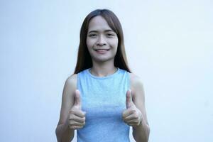 asian woman Thumbs up is a great symbol. photo