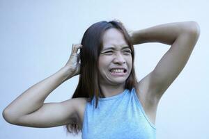 Asian woman has itchy scalp from dandruff photo