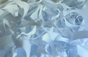 Shredded paper texture background, top view of many white paper strips. Pile of cut paper like box filler for shipping fragile items photo