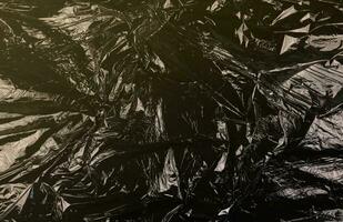 Texture of black plastic garbage disposable bag photo