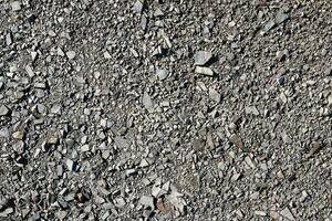 Background of shattered stony stones surface in mountain area. Texture with natural light photo