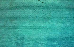 The texture of the brick wall of many rows of bricks painted in cyan color photo