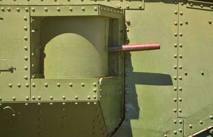 The texture of the wall of the tank, made of metal and reinforced with a multitude of bolts and rivets. Images of the covering of a combat vehicle from the Second World War with a guided machine gun photo