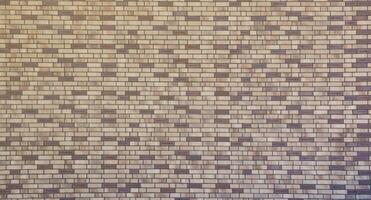 Dark brick wall pattern with chaotic masonry order. Background texture or resource for 3d texturing. Many bricks in big modern stone wall photo