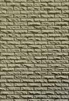 textura de pared de ladrillo de piedras de relieve bajo la luz del sol brillante foto