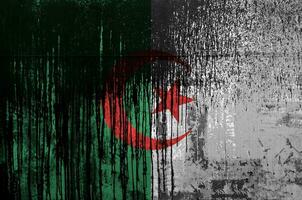 Algeria flag depicted in paint colors on old and dirty oil barrel wall closeup. Textured banner on rough background photo