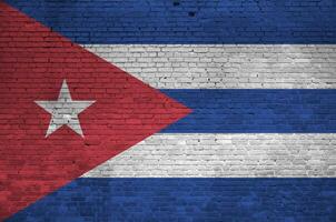 Cuba flag depicted in paint colors on old brick wall. Textured banner on big brick wall masonry background photo