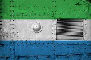 Sierra Leone flag depicted on side part of military armored tank closeup. Army forces conceptual background photo