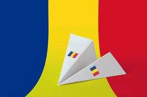 Romania flag depicted on paper origami airplane. Handmade arts concept photo