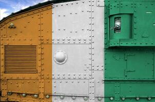 Ivory Coast flag depicted on side part of military armored tank closeup. Army forces conceptual background photo