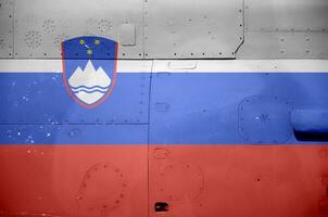 Slovenia flag depicted on side part of military armored helicopter closeup. Army forces aircraft conceptual background photo