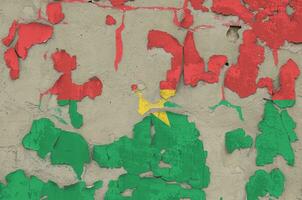Burkina Faso flag depicted in paint colors on old obsolete messy concrete wall closeup. Textured banner on rough background photo