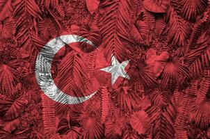 Turkey flag depicted on many leafs of monstera palm trees. Trendy fashionable backdrop photo