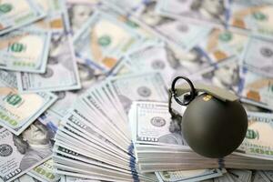 Grenade with a check against the background of huge amount of american dollar bills photo