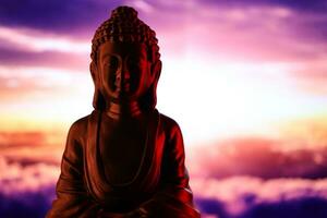 Buddha Purnima and Vesak day concept, Buddha statue with low key light against beautiful and colorful background. Meditation photo