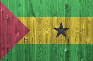 Sao Tome and Principe flag depicted in bright paint colors on old wooden wall. Textured banner on rough background photo