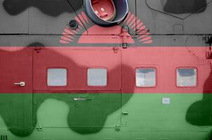 Malawi flag depicted on side part of military armored helicopter closeup. Army forces aircraft conceptual background photo