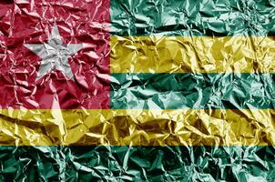 Togo flag depicted in paint colors on shiny crumpled aluminium foil closeup. Textured banner on rough background photo