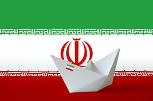 Iran flag depicted on paper origami ship closeup. Handmade arts concept photo