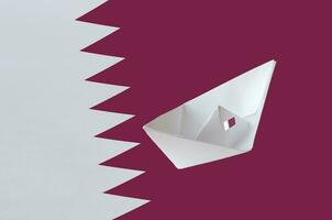Qatar flag depicted on paper origami ship closeup. Handmade arts concept photo