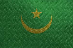 Mauritania flag depicted in paint colors on old brushed metal plate or wall closeup. Textured banner on rough background photo