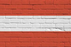 Austria flag depicted in paint colors on old brick wall. Textured banner on big brick wall masonry background photo