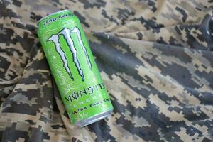 KYIV, UKRAINE - 4 MAY, 2023 Monster energy drink ultra paradise in green tin can with Monster energy drink logo photo