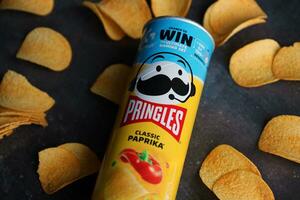 KYIV, UKRAINE - 4 MAY, 2023 Pringles tube of chips with rare classic paprika flavour photo