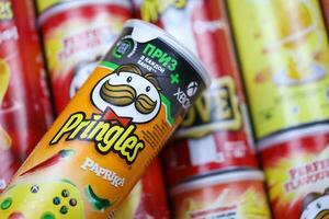 KHARKOV, UKRAINE - MARCH 30, 2021 Many Pringles cylinder chips boxes with varios colors and flavours. American brand of stackable potato-based crisps photo