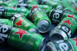 KHARKOV, UKRAINE - JULY 31, 2021 Green tin cans of Heineken lager beer produced by the Dutch brewing company Heineken N.V. photo