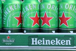 KHARKOV, UKRAINE - JULY 31, 2021 Green tin cans of Heineken lager beer produced by the Dutch brewing company Heineken N.V. photo