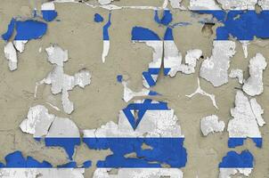 Israel flag depicted in paint colors on old obsolete messy concrete wall closeup. Textured banner on rough background photo