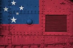 Samoa flag depicted on side part of military armored tank closeup. Army forces conceptual background photo