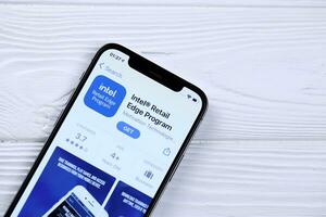 KHARKOV, UKRAINE - MARCH 5, 2021 Intel icon and application from App store on iPhone 12 pro display screen on white table photo