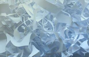 Shredded paper texture background, top view of many white paper strips. Pile of cut paper like box filler for shipping fragile items photo