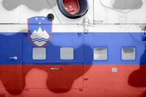 Slovenia flag depicted on side part of military armored helicopter closeup. Army forces aircraft conceptual background photo