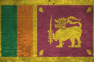 Sri Lanka flag depicted in paint colors on old brick wall. Textured banner on big brick wall masonry background photo