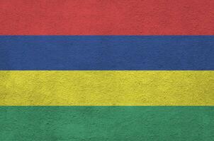 Mauritius flag depicted in bright paint colors on old relief plastering wall. Textured banner on rough background photo