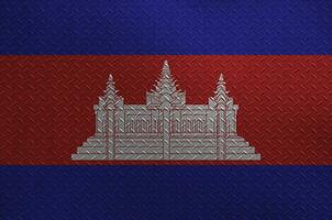 Cambodia flag depicted in paint colors on old brushed metal plate or wall closeup. Textured banner on rough background photo