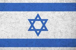 Israel flag depicted in bright paint colors on old relief plastering wall. Textured banner on rough background photo