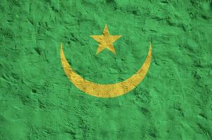 Mauritania flag depicted in bright paint colors on old relief plastering wall. Textured banner on rough background photo