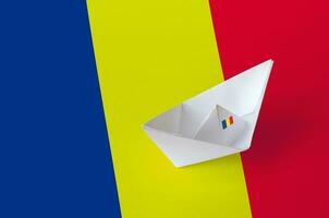 Romania flag depicted on paper origami ship closeup. Handmade arts concept photo