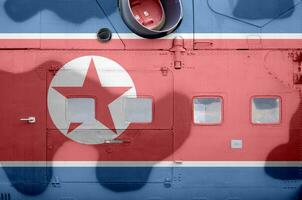 North Korea flag depicted on side part of military armored helicopter closeup. Army forces aircraft conceptual background photo