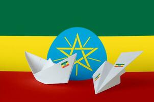 Ethiopia flag depicted on paper origami airplane and boat. Handmade arts concept photo