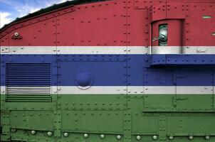 Gambia flag depicted on side part of military armored tank closeup. Army forces conceptual background photo