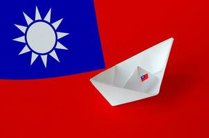 Taiwan flag depicted on paper origami ship closeup. Handmade arts concept photo