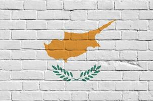 Cyprus flag depicted in paint colors on old brick wall. Textured banner on big brick wall masonry background photo