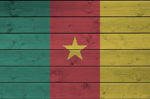 Cameroon flag depicted in bright paint colors on old wooden wall. Textured banner on rough background photo