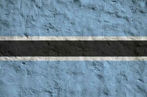 Botswana flag depicted in bright paint colors on old relief plastering wall. Textured banner on rough background photo
