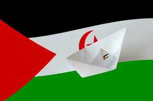 Western Sahara flag depicted on paper origami ship closeup. Handmade arts concept photo